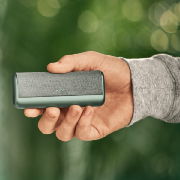 An IQOS ILUMA PRIME Holder in a person's hands.