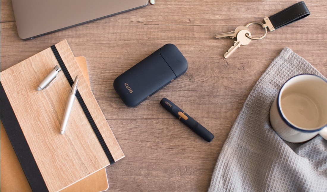 Black IQOS 2.4 PLUS Kit on a working desk