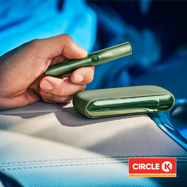 device on hands and circle k logo