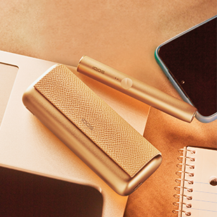 A boy and a girl talk with a gold IQOS DUO in her hand