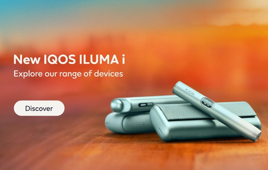 All IQOS ILUMA i series devices in orange blurred background with the text New IQOS ILUMA i Explore our range of devices and button Discover.